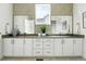 Stylish bathroom featuring a double vanity, modern fixtures, and chic wallpaper at 4855 Saddle Iron Rd, Castle Rock, CO 80104
