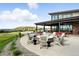Stylish clubhouse patio with comfortable seating around a fire pit, perfect for social gatherings and relaxation at 4855 Saddle Iron Rd, Castle Rock, CO 80104