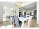 Open dining area with modern light fixture, view of porch, and kitchen access at 4855 Saddle Iron Rd, Castle Rock, CO 80104