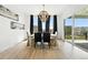 Elegant dining room with modern lighting, dark curtains, and neighborhood views at 4855 Saddle Iron Rd, Castle Rock, CO 80104