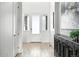 Bright foyer features neutral walls, wood floors, and a modern accent cabinet at 4855 Saddle Iron Rd, Castle Rock, CO 80104