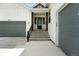 The exterior of this home includes a gray garage door and covered front porch with a metal railing at 4855 Saddle Iron Rd, Castle Rock, CO 80104