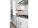 Bright kitchen features white cabinets, stainless steel appliances, and modern backsplash at 4855 Saddle Iron Rd, Castle Rock, CO 80104