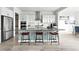 Modern kitchen with a large island, stainless steel appliances, and lots of storage space at 4855 Saddle Iron Rd, Castle Rock, CO 80104