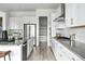 Galley kitchen with white cabinets, gray countertops, and stainless steel appliances at 4855 Saddle Iron Rd, Castle Rock, CO 80104