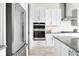 Modern kitchen featuring stainless steel appliances, white cabinets, and subway tile backsplash at 4855 Saddle Iron Rd, Castle Rock, CO 80104