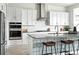 Bright modern kitchen featuring white cabinets, stainless steel appliances, and a beautiful tile island at 4855 Saddle Iron Rd, Castle Rock, CO 80104