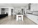 Spacious open concept kitchen featuring white cabinets and a center island with seating at 4855 Saddle Iron Rd, Castle Rock, CO 80104