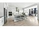 Spacious kitchen with white cabinetry, a patterned island, and modern appliances open to the dining area at 4855 Saddle Iron Rd, Castle Rock, CO 80104