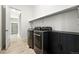 Modern laundry room featuring sleek appliances and custom cabinetry at 4855 Saddle Iron Rd, Castle Rock, CO 80104