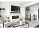Bright living room featuring a modern fireplace, TV, and sleek design elements at 4855 Saddle Iron Rd, Castle Rock, CO 80104