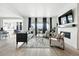 Bright living room with fireplace, large windows, and modern decor at 4855 Saddle Iron Rd, Castle Rock, CO 80104