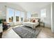 Bright primary bedroom with large windows, vaulted ceiling, and comfortable decor at 4855 Saddle Iron Rd, Castle Rock, CO 80104