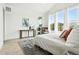 Spacious primary bedroom with modern decor, large windows, and cozy seating area at 4855 Saddle Iron Rd, Castle Rock, CO 80104