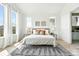 Tranquil primary bedroom with modern décor, large windows, and warm sunlight at 4855 Saddle Iron Rd, Castle Rock, CO 80104
