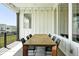 Covered outdoor patio with a large table and seating, perfect for entertaining guests and enjoying outdoor meals at 4855 Saddle Iron Rd, Castle Rock, CO 80104