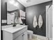 Modern bathroom with a vanity, dark walls, and a tiled walk-in shower at 2924 Echo Park Dr, Castle Rock, CO 80104