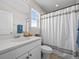 Modern bathroom featuring a sleek white vanity, stylish fixtures, and an elegant shower curtain at 2924 Echo Park Dr, Castle Rock, CO 80104
