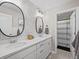 Bright bathroom featuring double sinks, quartz countertop, decorative mirrors and open view to the shower at 2924 Echo Park Dr, Castle Rock, CO 80104