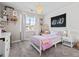 Charming bedroom features a unique decor and a hanging chair, complemented by a large window at 2924 Echo Park Dr, Castle Rock, CO 80104