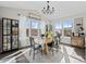 Sunlit dining room with large windows, modern chandelier, and ample seating at 2924 Echo Park Dr, Castle Rock, CO 80104