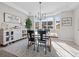 Sunlit dining room featuring elegant furnishings, a stylish light fixture, and large bay windows at 2924 Echo Park Dr, Castle Rock, CO 80104