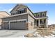 Beautiful two-story house with stone accents, a covered front porch, and manicured front yard at 2924 Echo Park Dr, Castle Rock, CO 80104