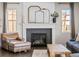 Close-up of the living room fireplace showcasing the mantel and comfortable armchair at 2924 Echo Park Dr, Castle Rock, CO 80104
