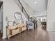 Bright foyer with hardwood floors, a staircase, and a decorative table, creating an inviting entrance at 2924 Echo Park Dr, Castle Rock, CO 80104