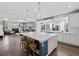Open concept kitchen featuring a large island with seating, pendant lights, and seamless flow into the living room at 2924 Echo Park Dr, Castle Rock, CO 80104
