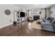 Inviting living room with fireplace, large TV, hardwood floors, and modern decor at 2924 Echo Park Dr, Castle Rock, CO 80104