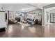 Spacious living room with hardwood floors, fireplace, large windows, and comfortable seating at 2924 Echo Park Dr, Castle Rock, CO 80104