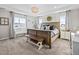 Spacious main bedroom featuring a wooden bed frame, bench seating, and bright natural light from the window at 2924 Echo Park Dr, Castle Rock, CO 80104