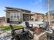 Outdoor patio with a cozy fire pit, chairs, and hot tub, great for entertaining and relaxing in the backyard at 2924 Echo Park Dr, Castle Rock, CO 80104