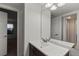 Bathroom features a vanity with single sink and large mirror at 14100 E Temple Dr # W04, Aurora, CO 80015