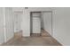 Spacious bedroom with mirrored closet doors and carpeting at 14100 E Temple Dr # W04, Aurora, CO 80015