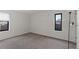 Spacious bedroom with neutral carpeting and two windows at 14100 E Temple Dr # W04, Aurora, CO 80015