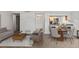 Combined living and dining area with kitchen and access to hallway at 14100 E Temple Dr # W04, Aurora, CO 80015