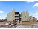 Multi-story condo building with stacked balconies, stone accents, and well-maintained landscaping at 14100 E Temple Dr # W04, Aurora, CO 80015