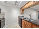 Kitchen with granite counters, tile backsplash, wood cabinets and stainless appliances at 14100 E Temple Dr # W04, Aurora, CO 80015