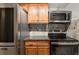 This kitchen features stainless steel appliances, wooden cabinets, and tiled backsplash at 14100 E Temple Dr # W04, Aurora, CO 80015
