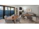Open living room with stone fireplace, dining area and sliding glass doors to patio at 14100 E Temple Dr # W04, Aurora, CO 80015