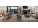 Bright living room features stone fireplace, dining area, and access to patio at 14100 E Temple Dr # W04, Aurora, CO 80015