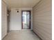 Private patio space with concrete floor and wood-look siding with view out to the property at 14100 E Temple Dr # W04, Aurora, CO 80015