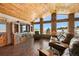 Open living room with hardwood floors, a large TV, and mountain views at 47980 Monarch Cir, Parker, CO 80138