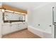 Spacious bathroom with double vanity, soaking tub, and updated fixtures, great for relaxing at 1904 S Union Pl, Lakewood, CO 80228