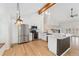 Bright kitchen with stainless steel appliances, white cabinets, and a marble island with pendant lighting at 1904 S Union Pl, Lakewood, CO 80228