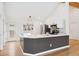 Modern kitchen with white cabinets, marble countertops, stainless steel appliances, and bar seating at 1904 S Union Pl, Lakewood, CO 80228