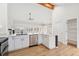 Modern kitchen with white cabinetry, stainless steel appliances, and a marble-topped island at 1904 S Union Pl, Lakewood, CO 80228
