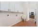Practical laundry room with overhead cabinets and sink, conveniently located near the kitchen at 1904 S Union Pl, Lakewood, CO 80228